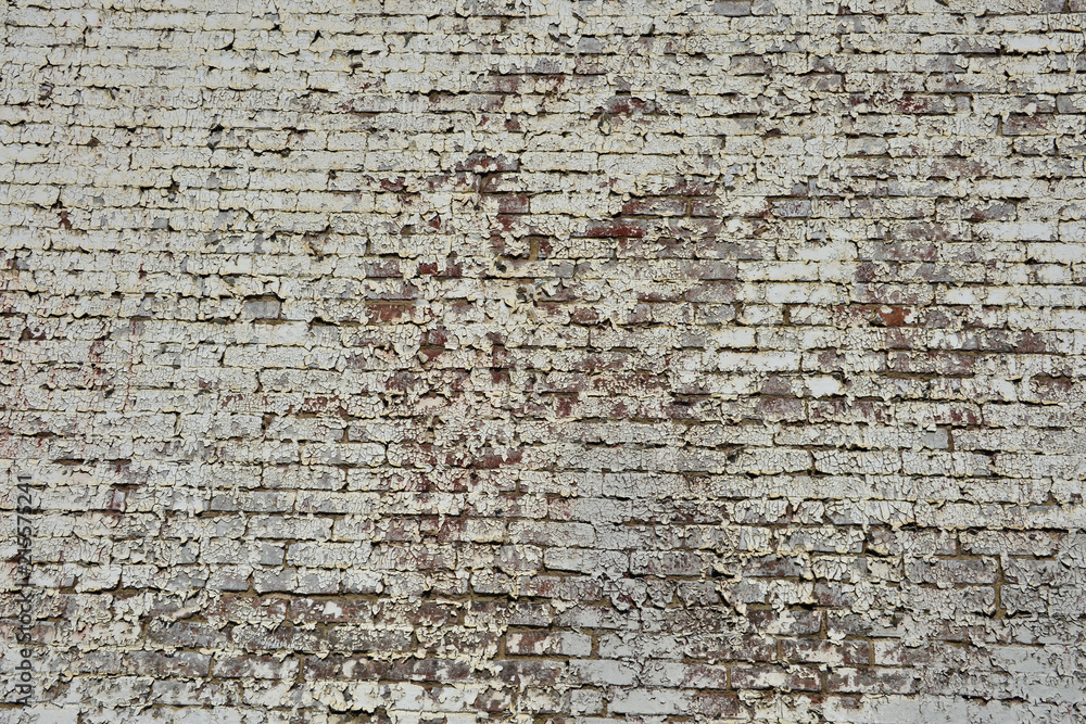 Peeling paint on brick wall on side of vintage building