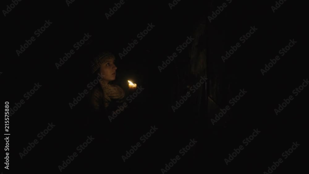 horror - girl with a candle in a dark basement horror - girl with a candle in a dark basement