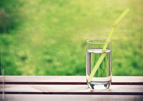 glass of water with pipe. Space for text