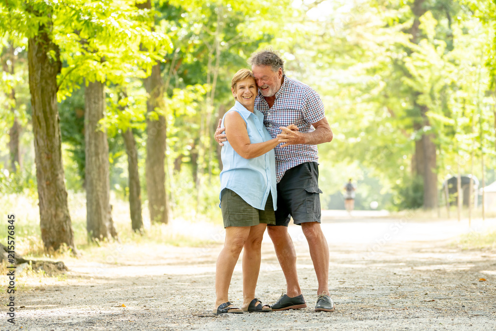 Happy smiling senior couple in love, dancing and having fun in the park. Being together, in love, retirement happy life concept. Happy smiling senior couple in love, dancing and having fun in the park. Being together, in love, retirement happy life concept.