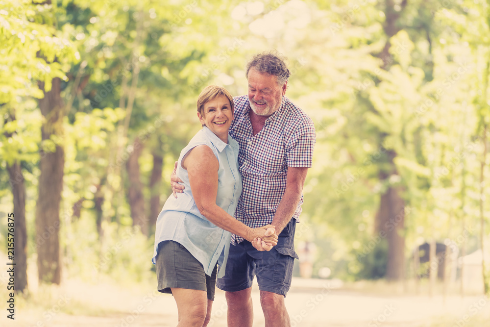 Happy smiling senior couple in love, dancing and having fun in the park. Being together, in love, retirement happy life concept. Happy smiling senior couple in love, dancing and having fun in the park. Being together, in love, retirement happy life concept.