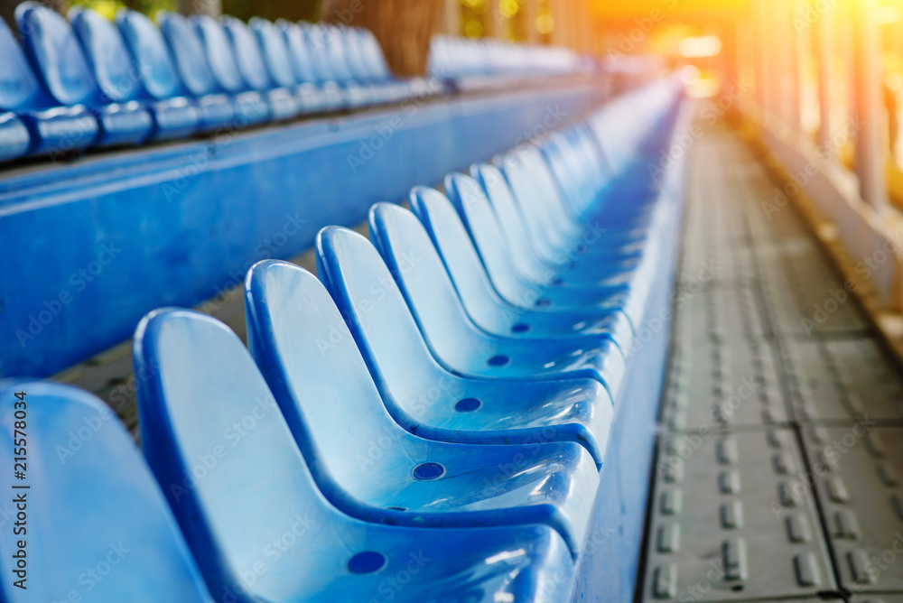 Empty plastic chairs in the stands of the stadium