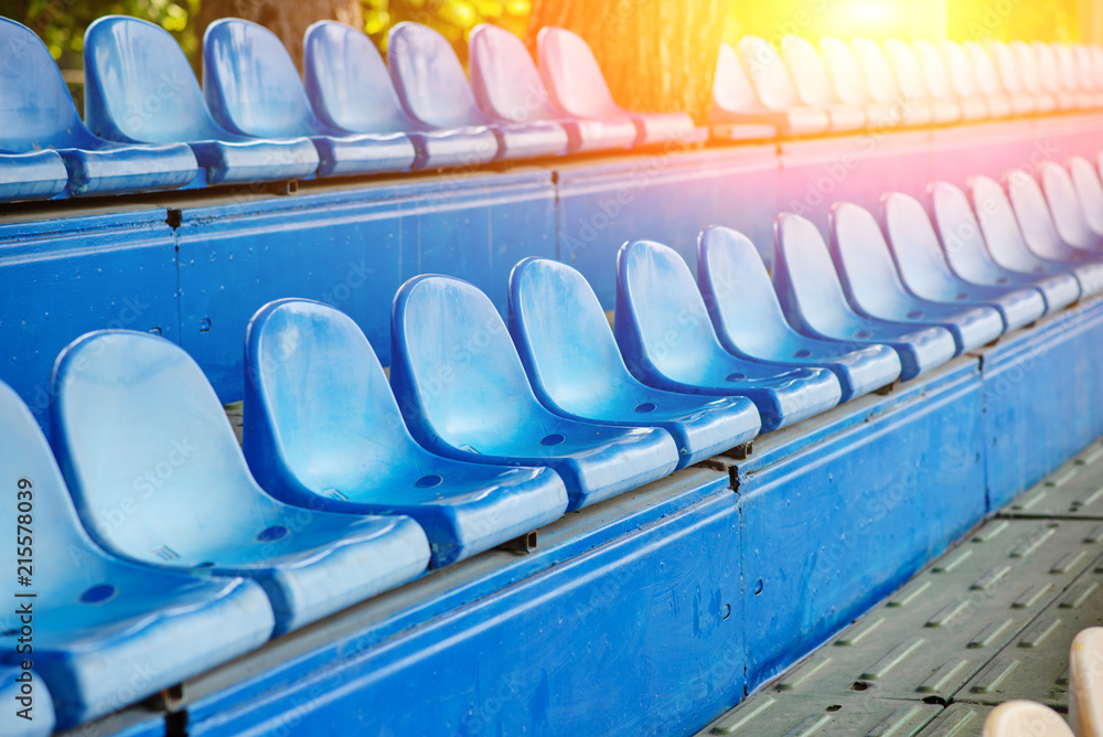Fototapeta premium Empty plastic chairs in the stands of the stadium