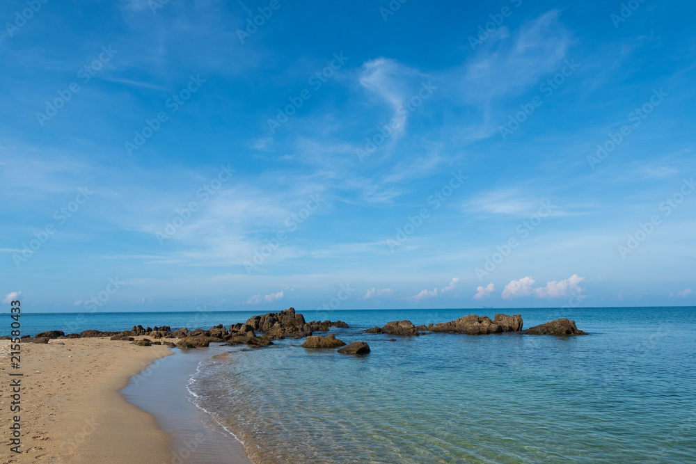 Beach and rocks with blue sky