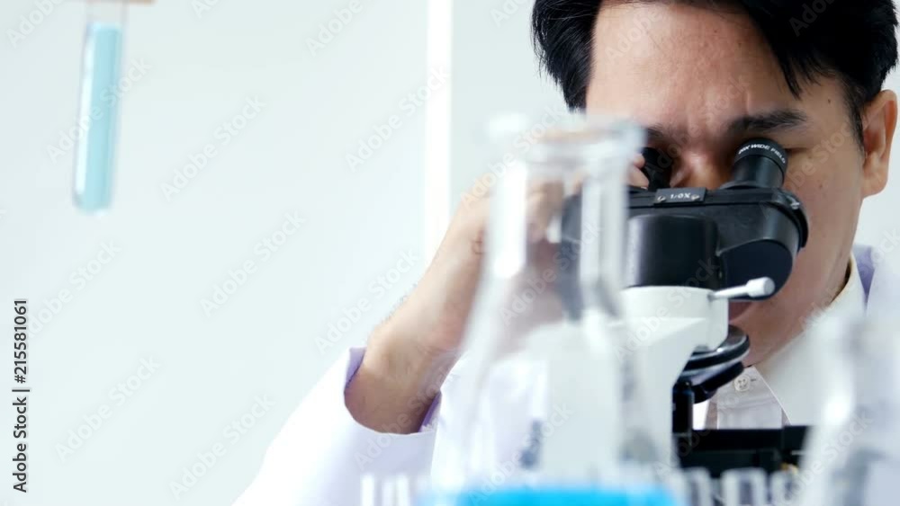 Scientist using microscope for work. Male Scientist working at laboratory. People with medical, science, doctor, healthcare concept. 4K Resolution. Scientist using microscope for work. Male Scientist working at laboratory. People with medical, science, doctor, healthcare concept. 4K Resolution.