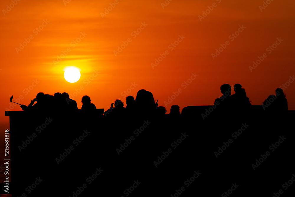 Silhouettes of people at sunset in the neighborhood of Miraflores (Lima, Peru)