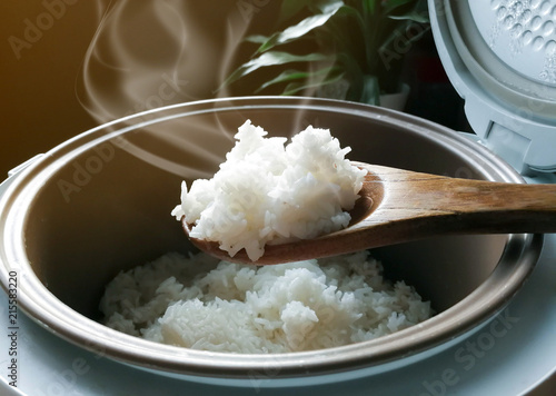 Jasmine rice cooking in electric rice cooker with steam. Soft Focus, Rustic tone picture. photo