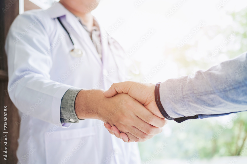 Confident Doctor shaking hands with patients talk in the hospital Confident Doctor shaking hands with patients talk in the hospital