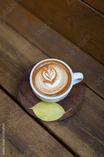 Cup of cappuccino on the wood background