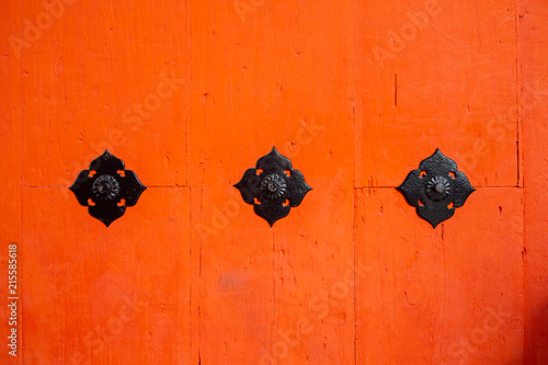 Close up of orange wooden door, Kyoto, Japan.