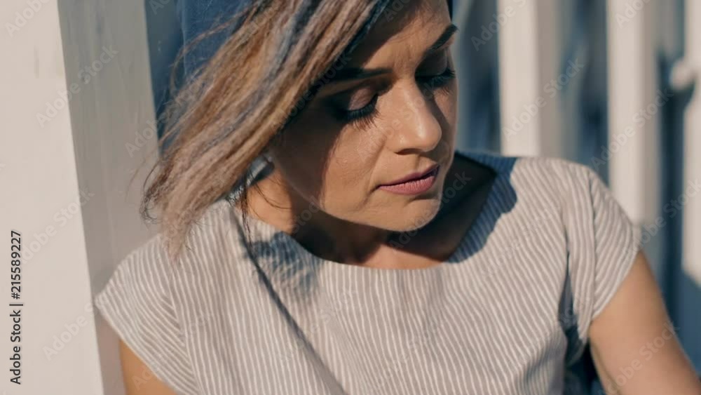 A beautiful and dreamy young woman in stylish clothes sits on the yellow sand near the piano. Unreal plot. close-up. A beautiful and dreamy young woman in stylish clothes sits on the yellow sand near the piano. Unreal plot. close-up.