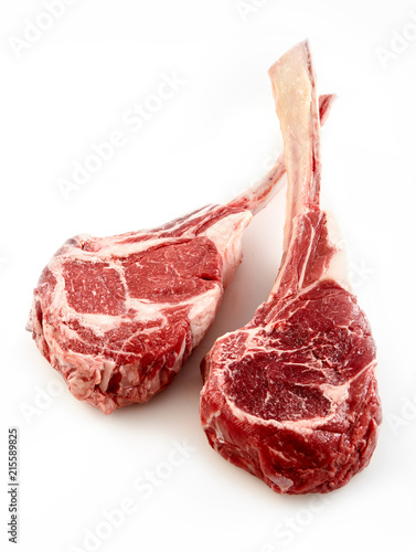 Two thick bone-in tomahawk or ribeye steaks photo