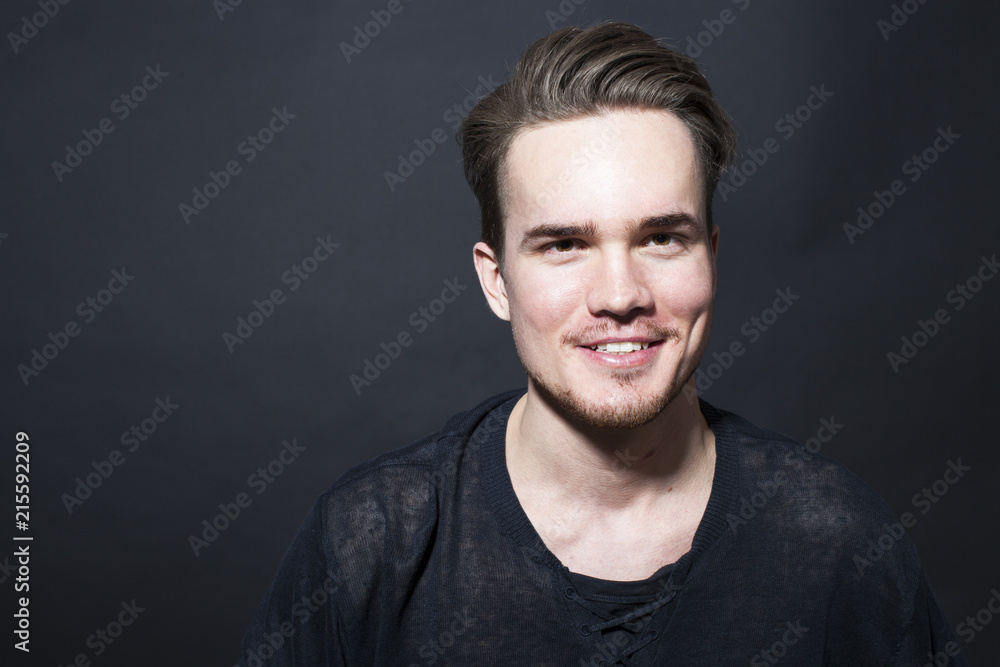 Studio portrait of young man on a dark background Studio portrait of young man on a dark background