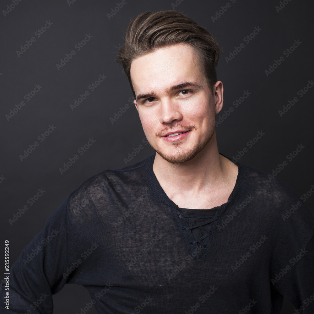 Studio portrait of young man on a dark background