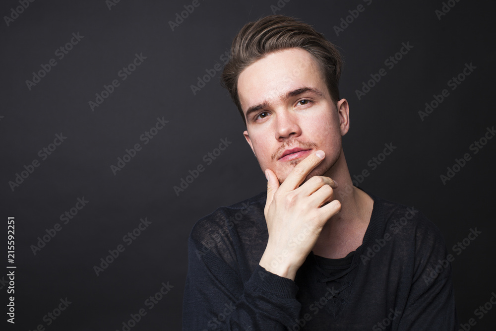 Studio portrait of young man on a dark background Studio portrait of young man on a dark background