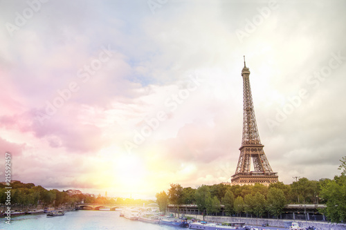 Romantic sunset background. Eiffel Tower with boats on Seine river in Paris, France.