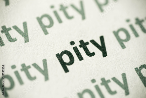 word pity printed on paper macro