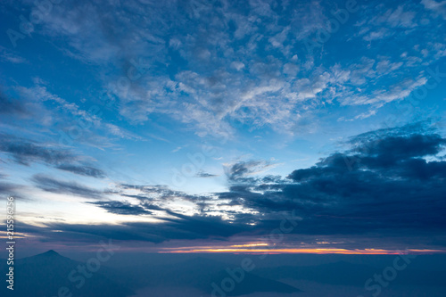 Morning dark sky with the blue cloud and rim light of the sunrise on the top of mountaing view of north side of Chaing-rai provice,Thailand.