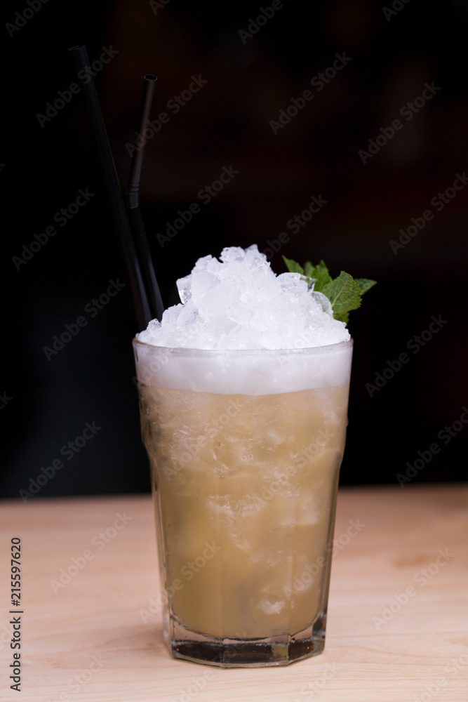Cool lemonade in glass on wooden table in Summer Cool lemonade in glass on wooden table in Summer