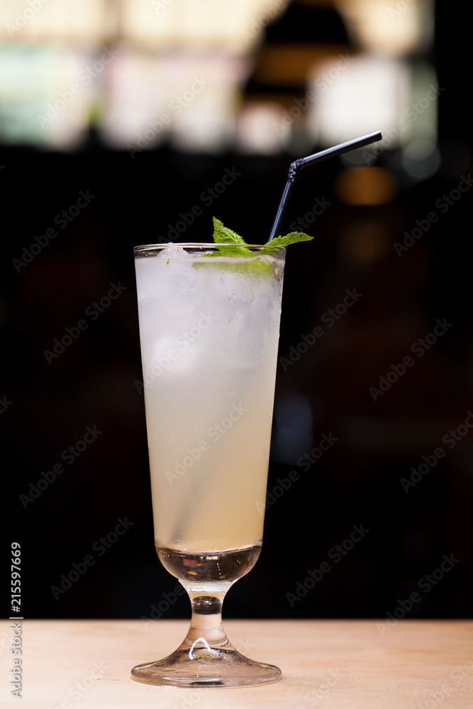 Cool lemonade in glass on wooden table in Summer Cool lemonade in glass on wooden table in Summer