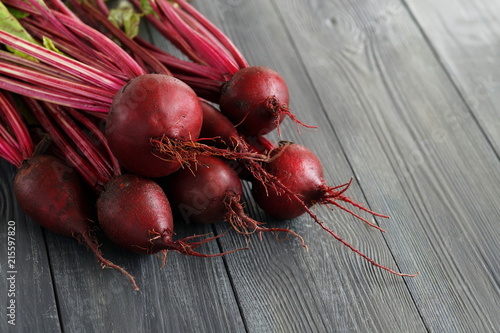 Fresh organic beets, beetroots on grey rustic wooden background. Close up. Copy space