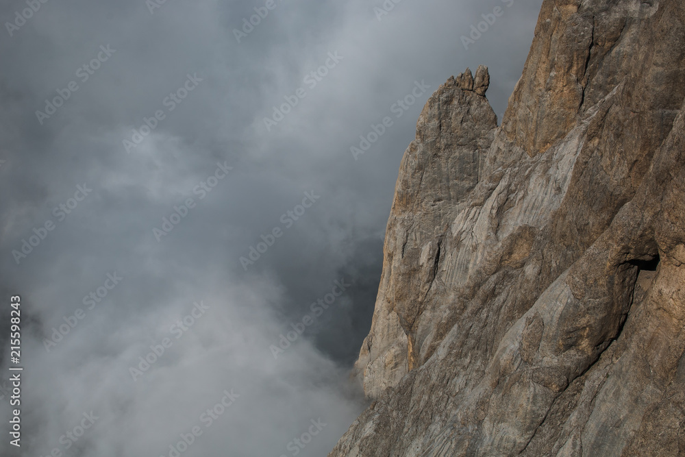 Parete roccioso della  Marmolada con nebbia