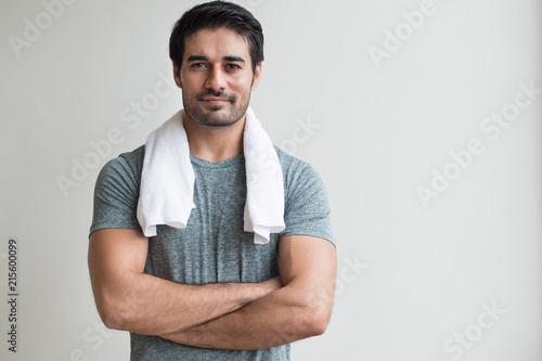 happy fitness man working out in gym; portrait of happy, smiling, positive asian indian man body training, working out in fitness gym; south asian, north indian adult man model