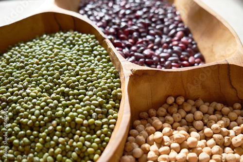 Collection set of beans, legumes, peas, lentils on wooden bowls