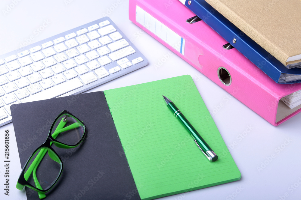 Office desk table with blank notebook, keyboard, other supplies and coffee cup. Top view with copy space Office desk table with blank notebook, keyboard, other supplies and coffee cup. Top view with copy space