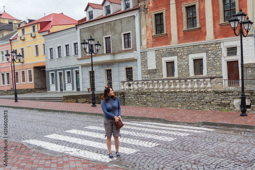 Woman at the crossing of the ulmtsy with colored houses. Travels