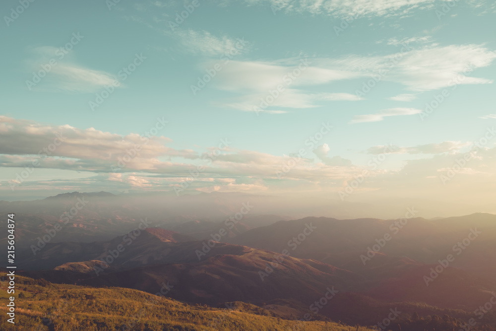 Autumn mountain landscape under sky with clouds in sunlight. vintage filter effect. Autumn mountain landscape under sky with clouds in sunlight. vintage filter effect.