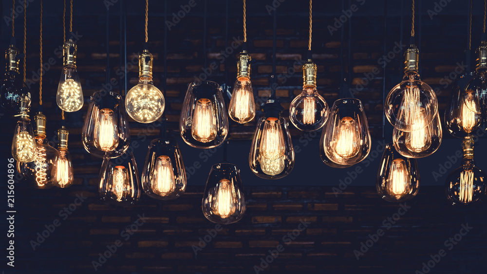 Beautiful vintage luxury light bulb hanging decor glowing in dark. Retro  filter effect style. Stock Photo | Adobe Stock