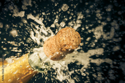 a champagne cork is popping out photo