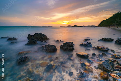 Long exposure shot of rocks on the sea at sunset