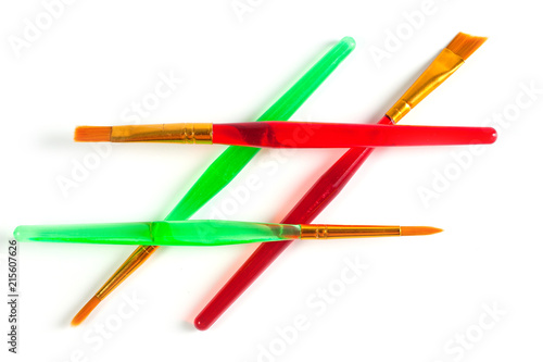 Paint brushes of various shapes and widths with bright plastic handles
