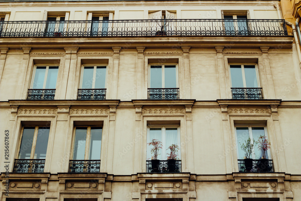 Paris residential buildings. Old Paris architecture, beautiful facades, typical french houses. Famous travel destinations in Europe. Background. City life, lifestyle and expensive real estate concept Paris residential buildings. Old Paris architecture, beautiful facades, typical french houses. Famous travel destinations in Europe. Background. City life, lifestyle and expensive real estate concept