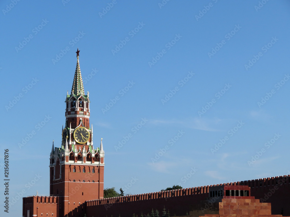 View of the Moscow Kremlin from Red square. Spasskaya tower on background of clear blue sky and Lenin's mausoleum