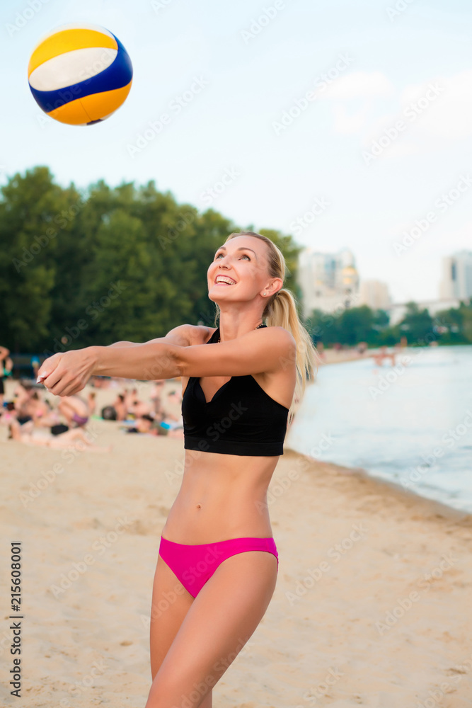 Cheerful blonde girl with perfect body playing volleyball at the beach  Stock Photo | Adobe Stock