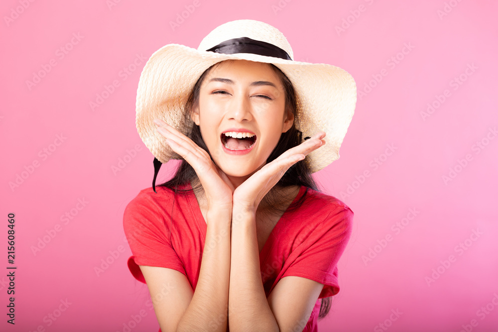 Portrait of a wow suprise smile attractive woman in summer outfit and hat posing while standing and looking at camera isolated over pink background. Portrait of a wow suprise smile attractive woman in summer outfit and hat posing while standing and looking at camera isolated over pink background.