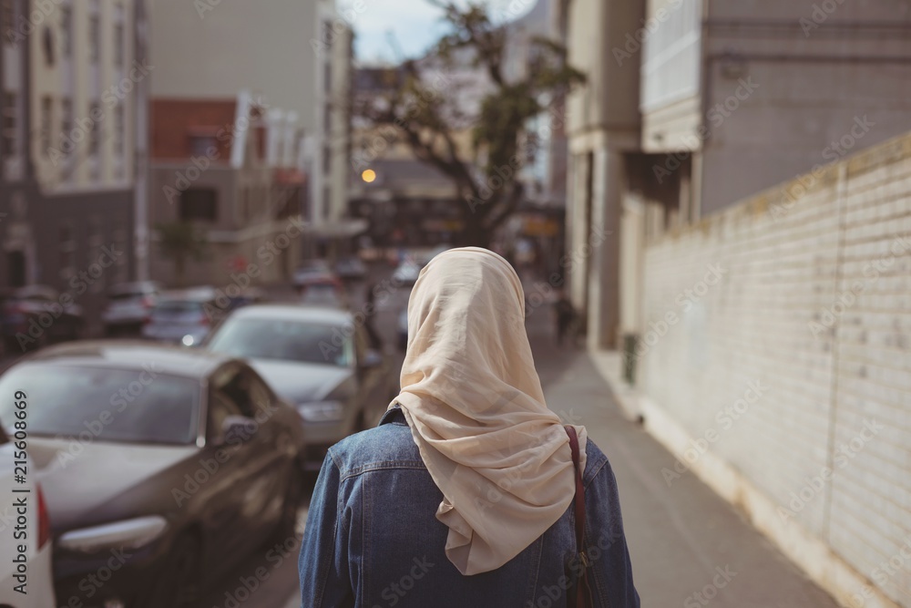 Hijab woman standing on sidewalk Hijab woman standing on sidewalk