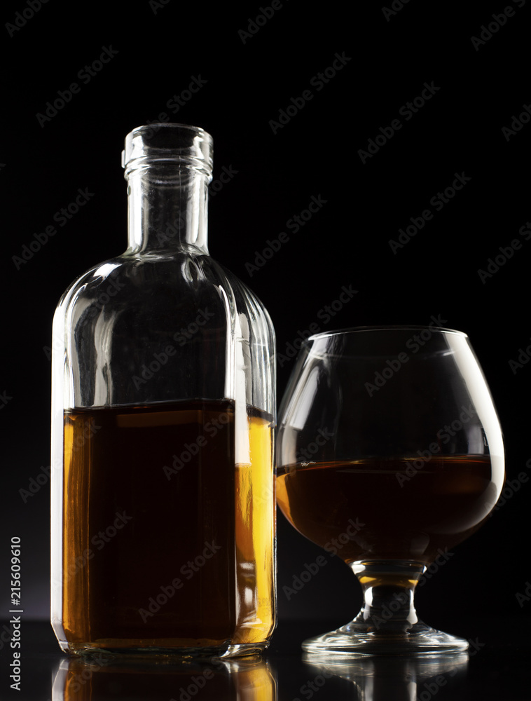 cognac glass and bottle dark studio shot cognac glass and bottle dark studio shot