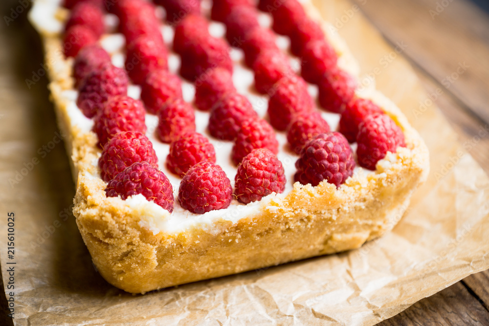 Fresh raspberry cheesecake on the rustic background. Selective focus. Shallow depth of field.