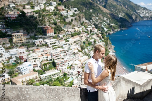 Young smiling tender romantic couple in Positano, Italy - love concept