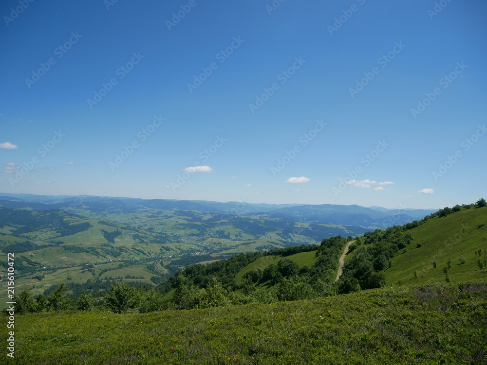 Carpathians / Ukraine - July 07 2017: Paraglider flying parachute in blue sky at a bright sunny summer day. Active lifestyle Carpathians / Ukraine - July 07 2017: Paraglider flying parachute in blue sky at a bright sunny summer day. Active lifestyle