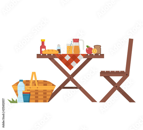 Wooden picnic table and chairs with cloth, juice jar, fruits, straw basket and bread. Outdoor dining concept with summer outing barbecue elements.
