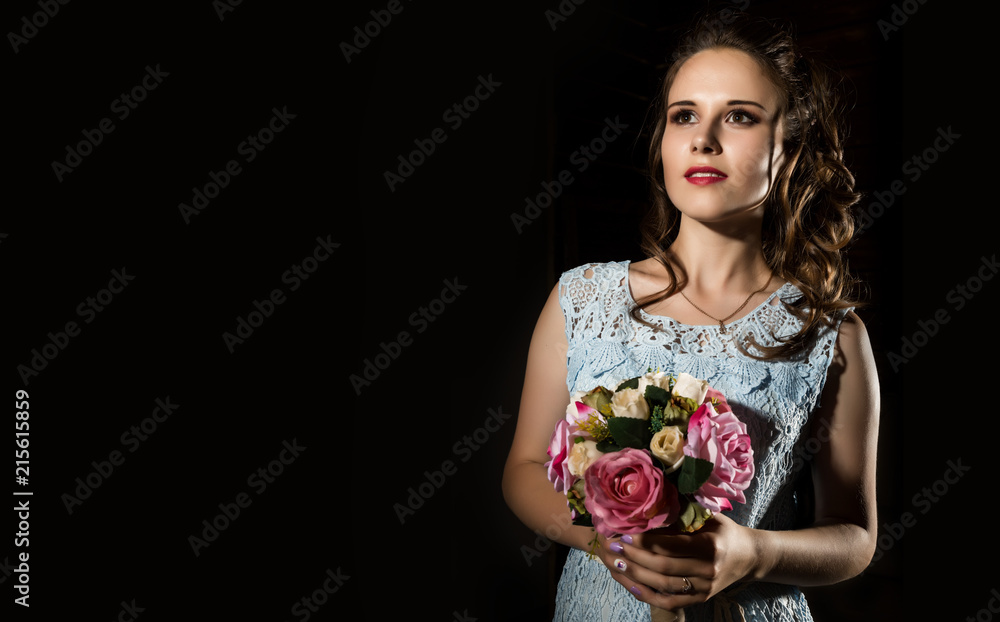 Naklejka premium happy young woman with pink flowers bouqet on dark background. free space for your text