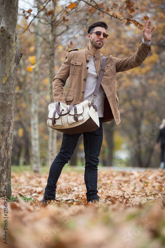Young adult man handsome posing in the wood, winter autumn day © arizanko