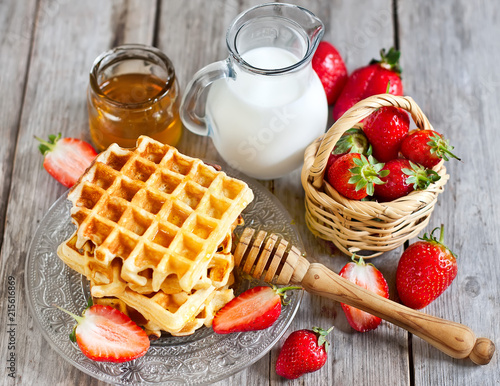 Waffles with strawberry abd honey photo