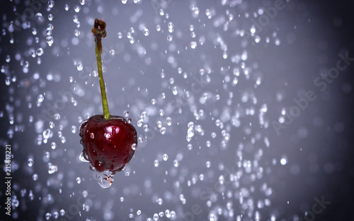 Cherry among water drops