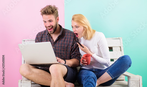 Modern occupation. Shocking content. Man girl create content blog social network. Couple surfing internet posting content social network. Couple content creators work with laptop and smartphone